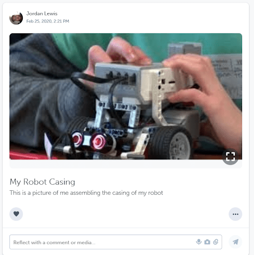 A student showcasing their work on a robot