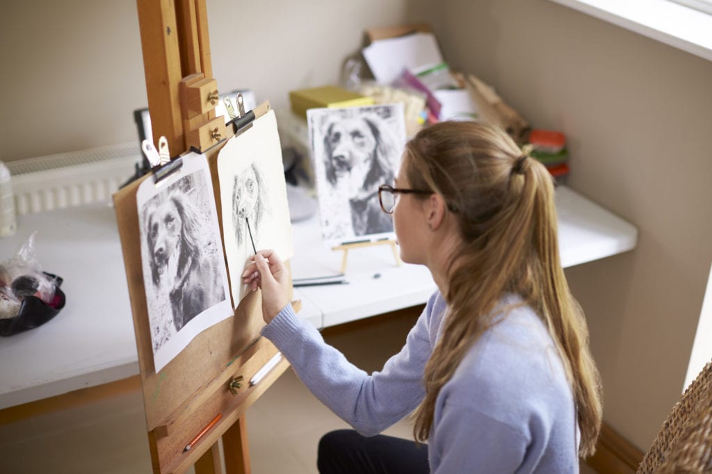 Student working on portrait of her pet dog